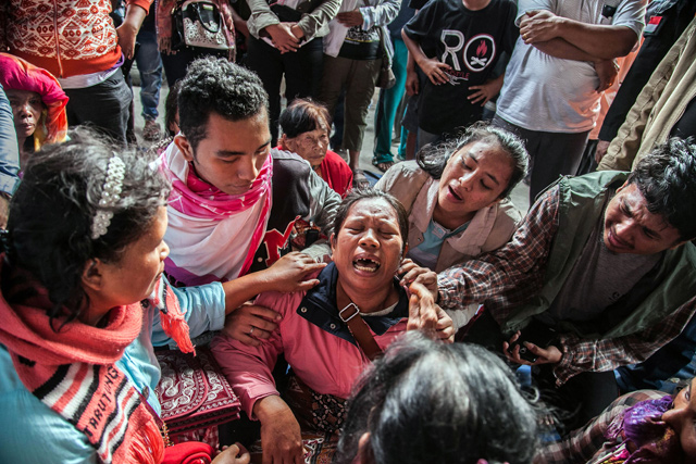 Family members mourn for their missing relatives who were passengers on a ferry that capsized on Monday at Toba Lake Ferry Port, in the province of North Sumatra, on Wednesday (AFP photo)