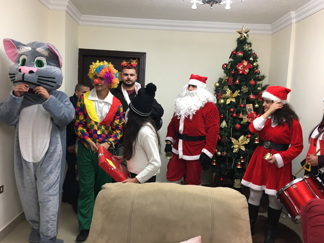 Two years ago, a group in Fuheis decided to give away presents and cheer up children, in what has become an annual activity. Members of the group dressed up and brought presents to the less fortunate on Sunday  (Photo by Muath Freij)