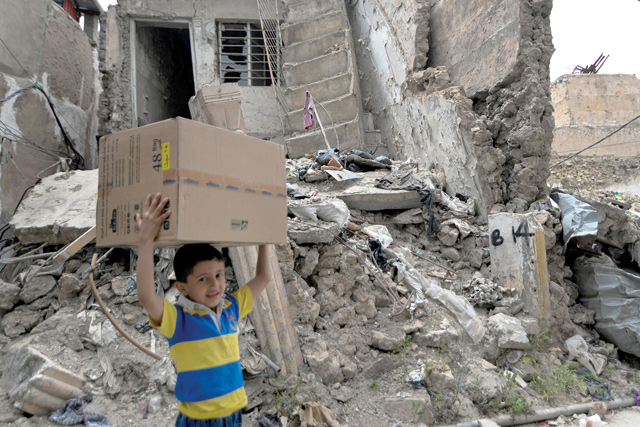 A boy walks past the rubble of destroyed houses in the war-ravaged old part of Iraq's northern city Mosul, a site heavily damaged by the Daesh terror group fighters in the 2017 battle for the city, on April 21 (AFP photo)