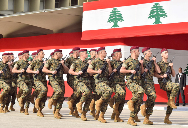 In this file photo taken on November 22, 2019, Lebanese army soldiers march before the president, prime minister, and parliament speaker during a military parade commemorating the 76th anniversary of Lebanese independence from France at the defence ministry headquarters in Yarze near the presidential palace of Baabda southeast of the capital (AFP photo)