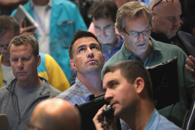 Traders fill orders in the S&P options pit at the Cboe Global Markets exchange shortly after the Federal Reserve announced it was raising interest rates on Wednesday in Chicago, Illinois  (AFP photo)