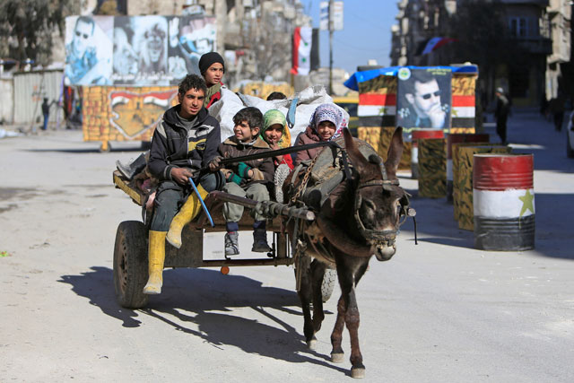 Children ride a donkey cart along a street in Aleppo, Syria, on Thursday (Reuters photo)