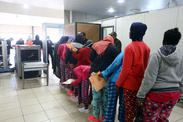 A group of deportee illegal immigrants wait before boarding to a plane, heading to Nigeria during their deportation at Mitiga International Airport in Tripoli, Libya, on Tuesday (Anadolu Agency photo)
