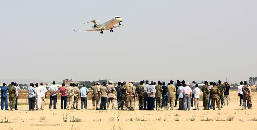 A Libyan Airlines aircraft flies over Tripoli International Airport, after forces belonging to the Libyan unity government took control of the facility, on Thursday (AFP photo)
