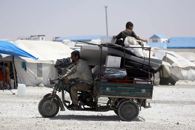 A displaced Syrian man, who fled the countryside surrounding the Daesh group stronghold of Raqqa, drives his tuktuk at a temporary camp in the village of Ain Issa on  Tuesday (AFP photo)
