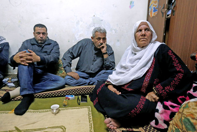 Palestinian refugee family watches a televised broadcast of US President Donald Trump delivering an address where he is expected to announce that the United States recognises Jerusalem as the capital of Israel, at Al Baqaa Palestinian refugee camp, near Amman, Jordan, on Wednesday (Reuters photo)
