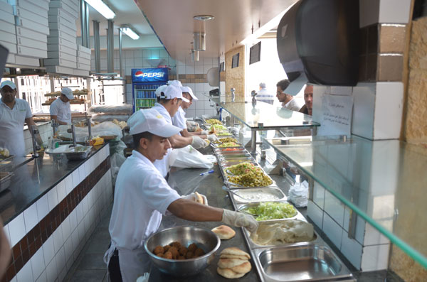 Workers at a local restaurant in Amman prepare falafel sandwiches recently (Photo by Muath Freij)