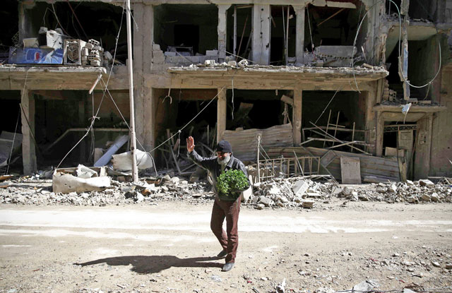A man is seen in the besieged town of Douma in Eastern Ghouta in Damascus, Syria, on Tuesday (Reuters photo)