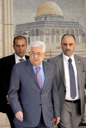 Palestinian President Mahmoud Abbas walks during a welcoming ceremony in Ramallah, in the occupied West Bank, on Friday. The president was hospitalised on Sunday (Reuters photo)
