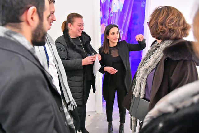 Artist Yasmeen Sabri (2nd from right) talks to attendees of her ‘Transcendence’ exhibit, in this undated photo (Photo courtesy of Wadi Finan)