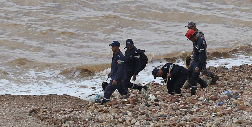 Civil defence members search for survivors after rain storms unleashed flashfloods, near the Dead Sea, Jordan, on Friday (AFP photo)