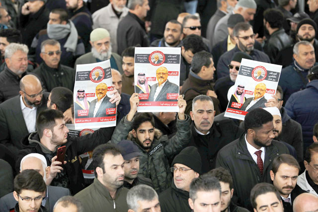 People holding photo of Saudi journalist Jamal Khashoggi attend a symbolic funeral prayer for Khashoggi at the courtyard of Fatih Mosque in Istanbul, Turkey, on Friday (Reuters photo)