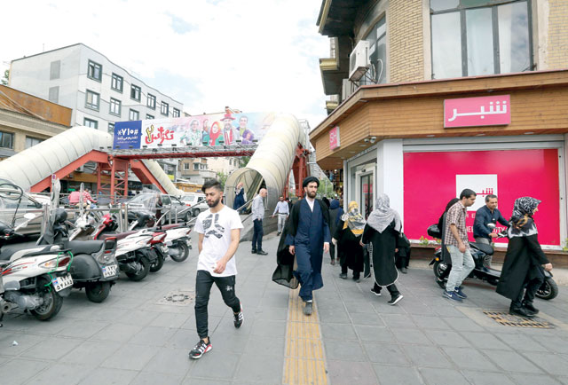 Iranians walk through Tajrish square in northern Tehran on Wednesday (AFP photo)