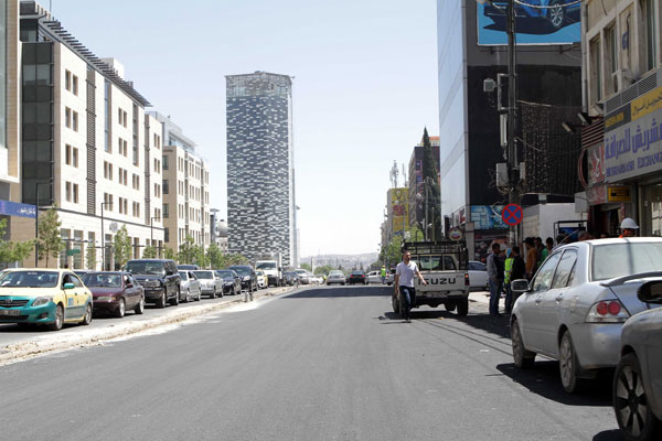 Owners of commercial shops and restaurants on Suleiman Nabulsi Street (right) complain that issuing traffic tickets to those who parking there is driving away customers (Photo by Hassan Tamimi)