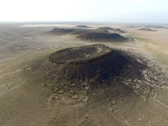 In this April 23 photo taken by a drone, 8,000-year old stone structures stick out from the natural landscape of the black basalt desert of eastern Jordan (AP photo)