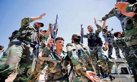 In this file photo, Syrian army soldiers gesture as they hold their weapons in Quneitra, on Friday (Reuters photo)
