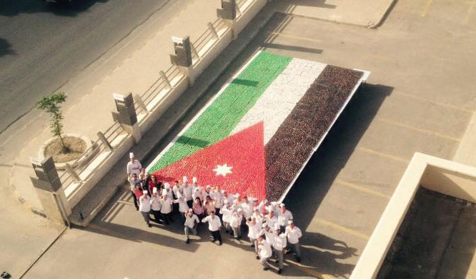 Chefs showcase a 12-metre-long and 6-metre wide Jordanian flag made using 15,000 cupcakes in Amman on Monday  (Photo courtesy of Royal Academy of Culinary Arts)