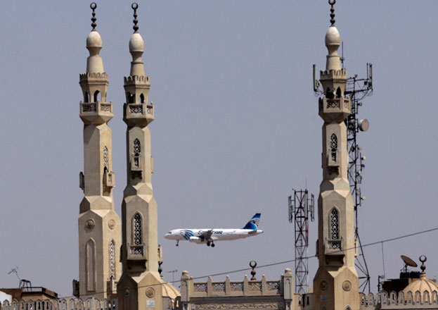 In this May 21 file photo, an EgyptAir plane flies past minarets of a mosque as it approaches Cairo International Airport, in Cairo, Egypt (AP photo)