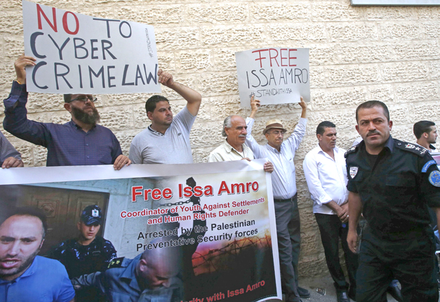 Palestinian supporters of activist Issa Amro, who was released on bail by a Palestinian court earlier on Sunday following his prior arrest on September 4, take part in a protest in the West Bank city of Hebron (AFP photo)