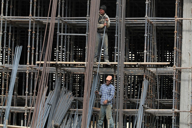 Guest labourers work at a construction site in Amman recently  (Photo by Khaled Oudat)