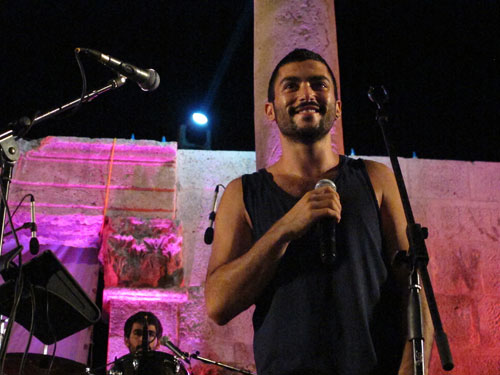 In this September 14, 2012 photo, Hamed Sinno, 24, lead singer and songwriter of the Lebanese group Mashrou' Leila performs with the band at the ancient Roman Theatre in Amman (AP photo by Diaa Hadid)