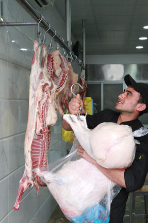 A butcher prepares meat in Amman recently (Photo by Hassan Tamimi)