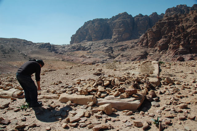 This undated handout image shows archaeologist Christopher A. Tuttle investigating the doorsill of the small building on the newly discovered platform in Petra, some 235km south of Amman (Photo courtesy of Council of American Overseas Research Centers/G. al Faqeer via AP)