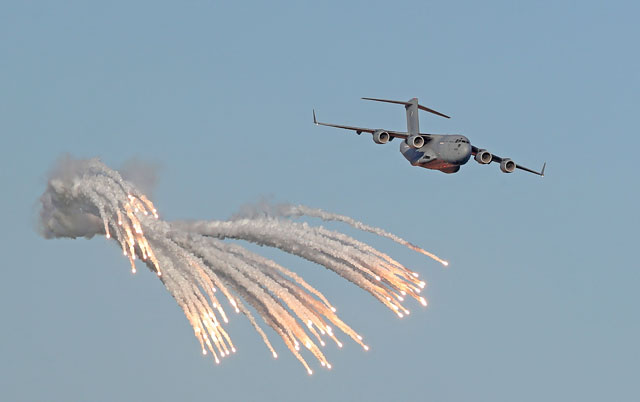 This file photo taken on December 17, 2017, shows a military aircraft performing near flares during Qatar's national day celebrations in Doha (AFP photo)