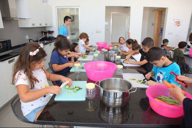Children learn how to cook during the Art and Giving summer camp at Haya Cultural Centre in Amman recently (Photo courtesy of Haya Cultural Centre)