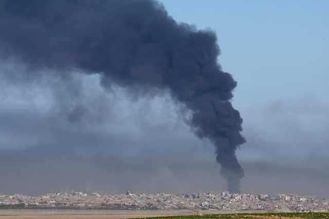 A photo taken from a position in southern Israel, along the border with the Gaza Strip, shows smoke billowing over the Palestinian territory during Israeli bombardment on December 29, 2023 (AFP photo)