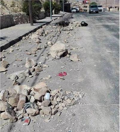 A photo posted on Maan City Facebook page shows a street partially blocked by rocks in Wadi Musa on Friday (Photo courtesy of Maan City Facebook page)