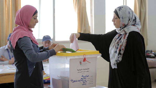 A woman casts her ballot at a polling station in Amman on Tuesday (Photo by Hassan Tamimi)