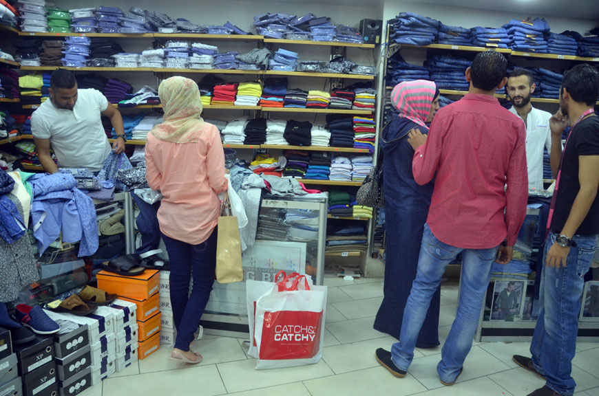 Customers shop for clothes at a store in Jabal Hussein in Amman on Wednesday (Photo by Muath Freij)