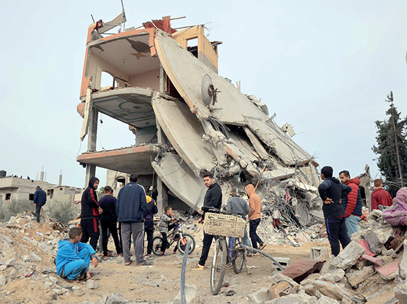 Palestinians check the rubble following Israeli bombardment in Khan Yunis in the southern Gaza Strip on Thursday (AFP photo)