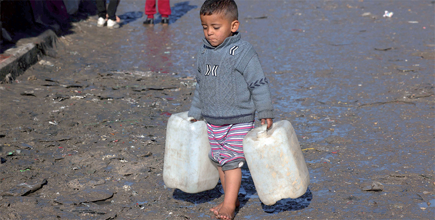 A young boy carries empty jerricans in Rafah in the southern Gaza Strip on Saturday (AFP photo)