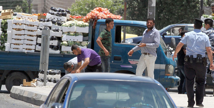 Street vendors sell vegetables on the side of the road in Amman on Tuesday (Photo by Osama Aqarbeh)