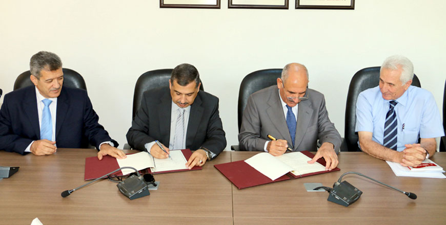 Deputy Prime Minister for Services and Minister of Education Mohammad Thneibat and Labour Minister Ali Ghezawi sign a deal to implement a vocational training programme (Petra photo)