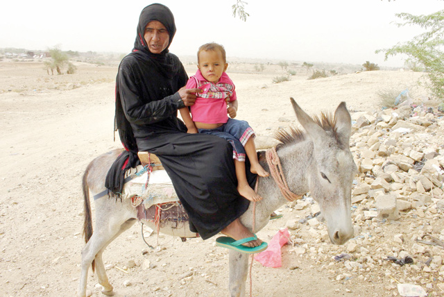 A displaced Yemeni mother from the city of Hodeid rides on a donkey with her child as they head to a health clinic in the northern district of Yemen's Hajjah province on Monday (AFP photo)