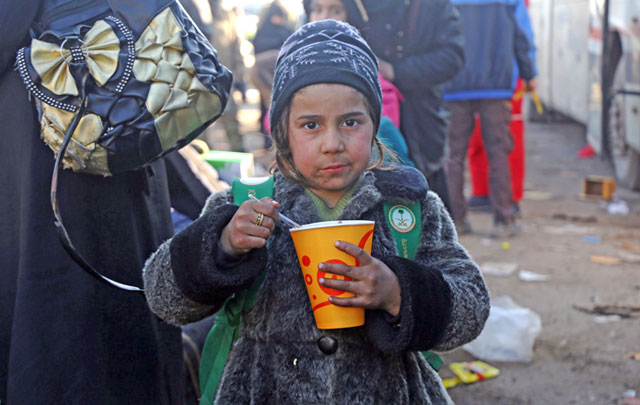 A Syrian girl, who was evacuated from the last rebel-held pockets of Syria’s northen city of Aleppo, eats upon arriving on Tuesday in the opposition-controlled Khan Al Assal region, west of the embattled city (AFP photo)