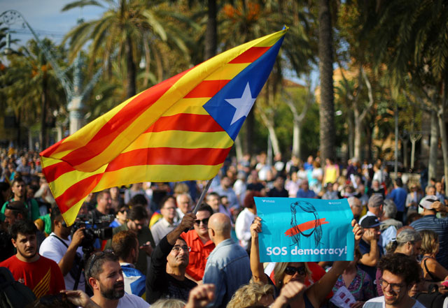 A man waves a separatist Catalonian flag at a rally in support of independence in Barcelona, Spain, on Tuesday (Reuters photo)
