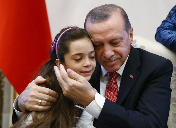 Turkey’s President Recep Tayyip Erdogan embraces Bana Al Abed, 7, from Aleppo, Syria, at his Presidential Palace in Ankara, Turkey, on Wednesday (AP photo)