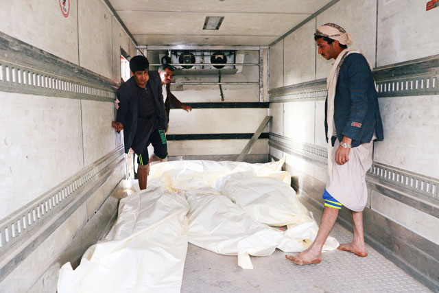 People look at coffins of people killed by air strikes in Saada, Yemen, on Wednesday (Reuters photo)