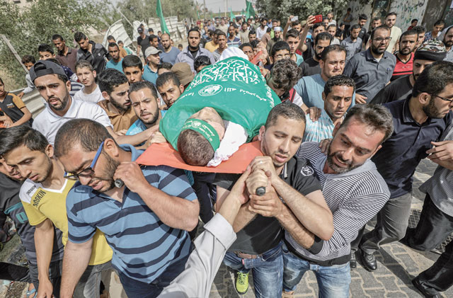 Palestinians carry the dead body of 20-year-old Mohammed Mazen Alyan, who died from wounds sustained after Israeli forces opened fire on protesters, during a funeral ceremony at Al Nusirat refugee camp in Gaza, Gaza City, on May 19 (Anadolu Agency photo)