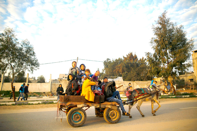 Palestinian children ride a donkey cart to school in Beit Lahia in the northern Gaza Strip, on Tuesday (AFP photo)