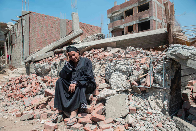A photo taken in Cairo on July 20 shows Egyptian Shoukran Rashwan, 75, sitting on the rubble of her house that was demolished in Cairo's Warraq Island (AFP photo)