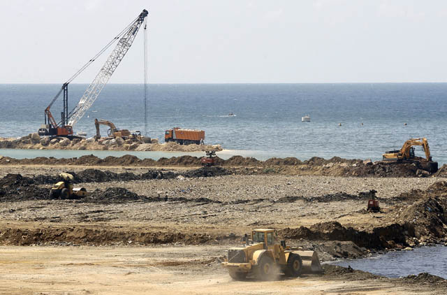 Trucks and bulldozers tip rubbish into the Mediterranean Sea at Borj Hammoud, on the northern outskirts of the Lebanese capital Beirut, on Wednesday (AFP photo)