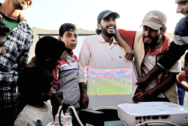 Displaced Syrians watch a World Cup football match in Ain Issa camp in Raqqa province on Sunday (AFP photo)
