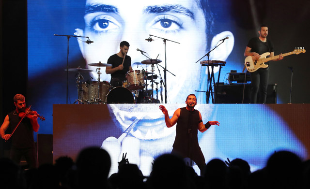 Hamed Sinno (centre), the lead singer of Lebanese band Mashrou Leila, performs on stage at the Dubai International Marine Club during a music festival in the United Arab Emirates, on April 7 (AFP photo)