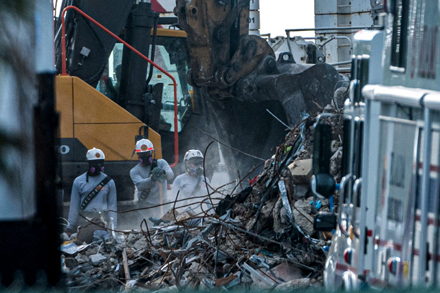 Search and rescue teams look for possible survivors in the partially collapsed 12-storey Champlain Towers South condo building on Monday in Surfside, Florida (AFP photo)