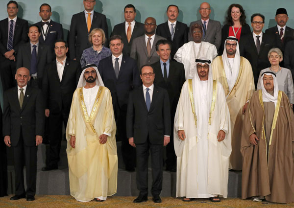 UAE Prime Minister Sheikh Mohammed Bin Rashid Al Maktoum (front-centre left), French President Francois Hollande (front-centre) and Crown Prince of Abu Dhabi Sheikh Mohammad Bin Zayed Al Nahyan (front-centre right), pose for a group photo during the closing ceremony of an international conference on protecting the world’s cultural heritage on Saturday (AFP photo)